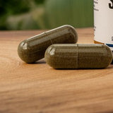 Shilajit capsules placed on a wooden surface with a natural background