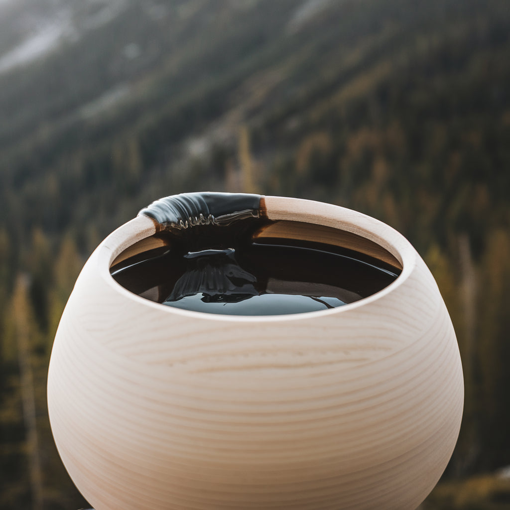 A jar of shilajit in a forest